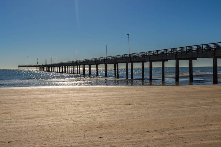 Ocean pier in Port Aransas, Texas viewed from the beach