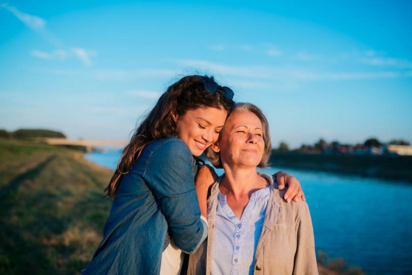 Mother and daughter walking on the beach