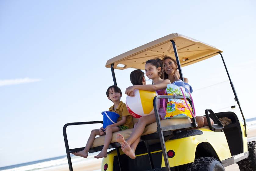 Family in a golf cart on the beach